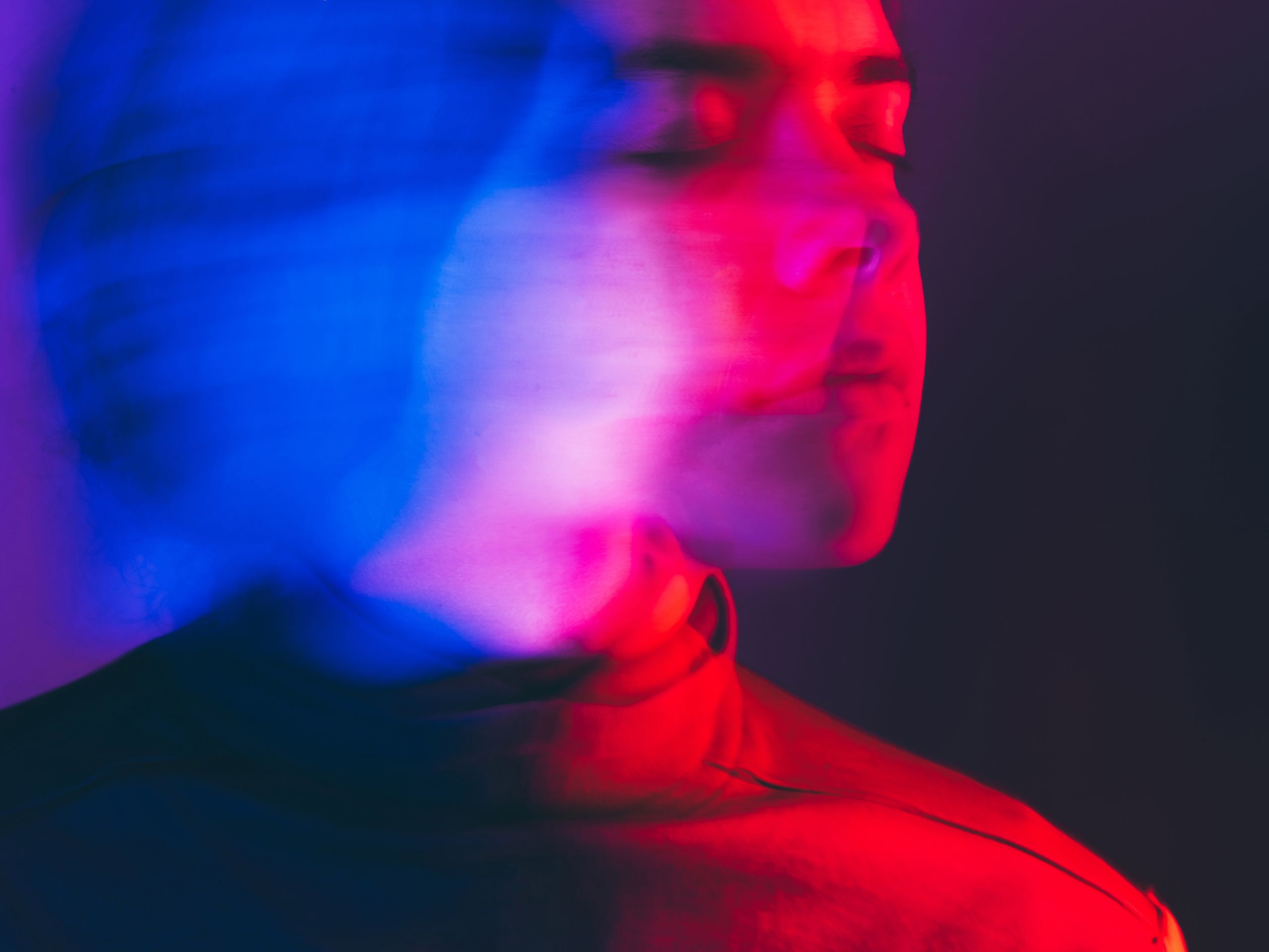 Image may contain Head Person Face Light Photography Portrait Purple Adult Body Part and Neck