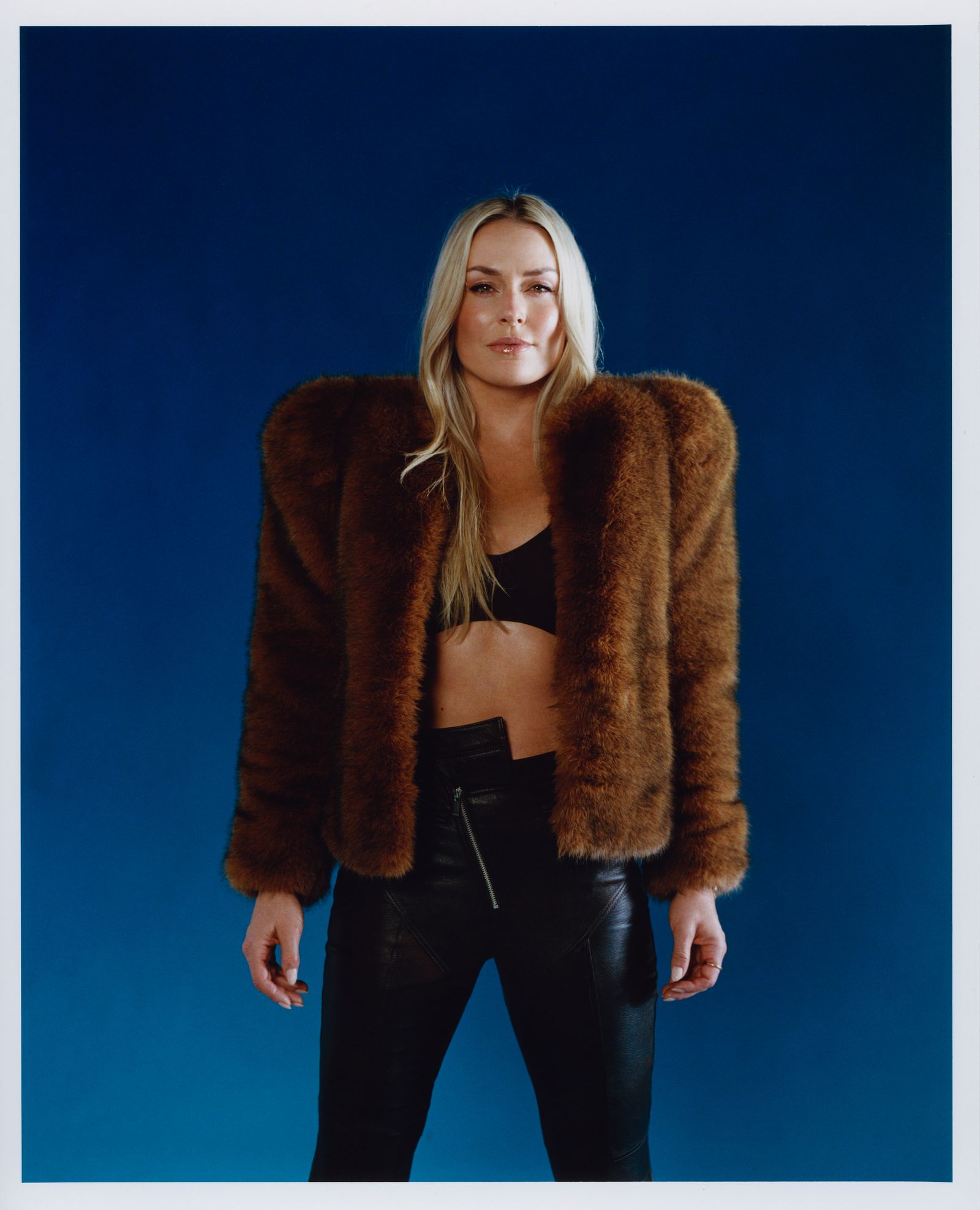 Image may contain Lindsey Vonn Clothing Coat Jacket Adult Person Knitwear Sweater Fur Jeans and Pants